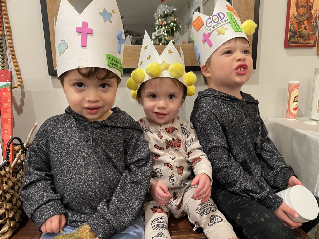 3 young children wearing handmade paper crowns for Epiphany liturgical living at home