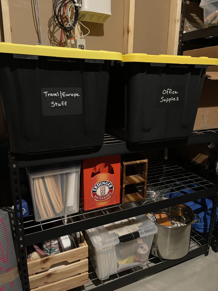 2 large plastic storage bins sitting on a shelf