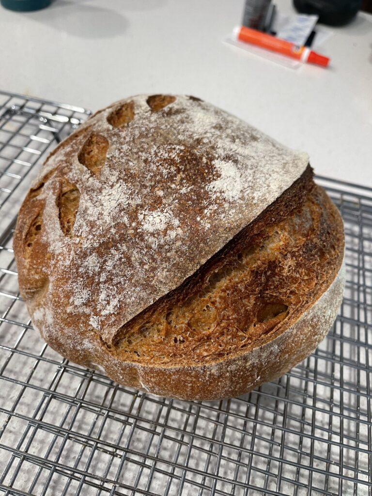 sourdough bread with a leaf and curved line pattern